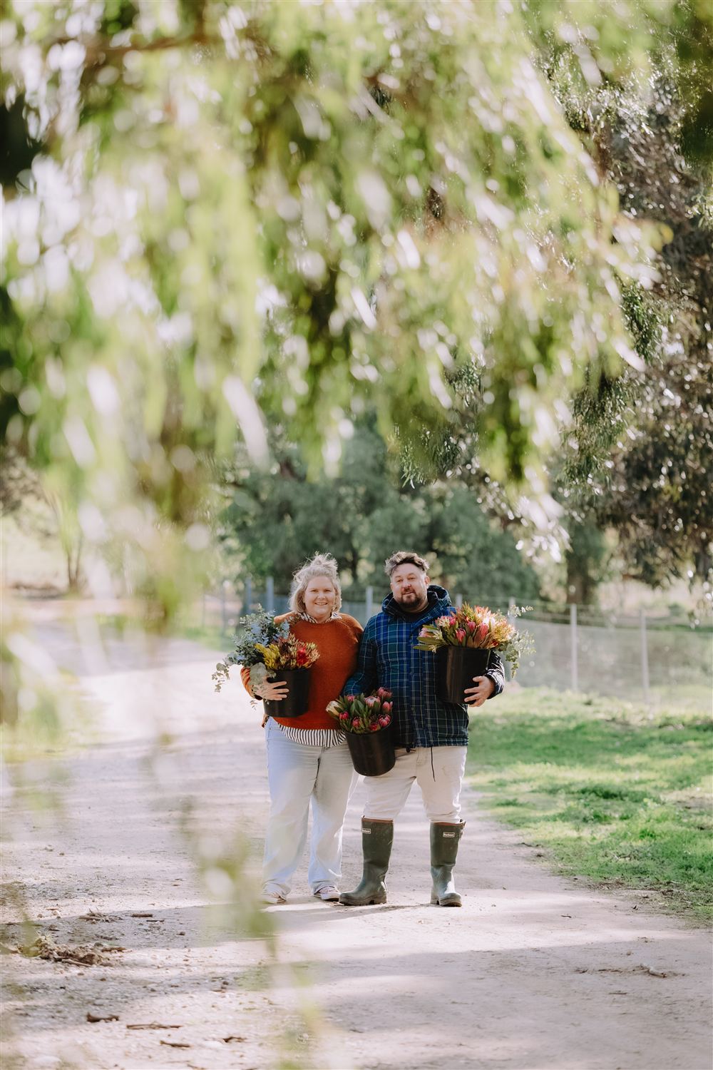 Walking down the farm track under the gum trees carrying bunches of flowers